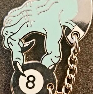 Hand chained to magic 8 ball pin